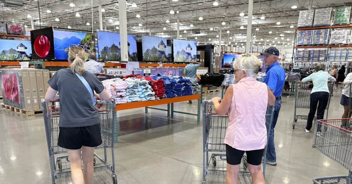 Shoppers push carts into a Costco warehouse Friday, Aug. 4, 2023, in Thornton, Colo. The stickiness of inflation could endanger the possibility that the Fed will achieve a rare "soft landing" — a scenario in which it manages to slow inflation to its target level through higher interest rates without derailing the economy.(AP Photo/David Zalubowski)