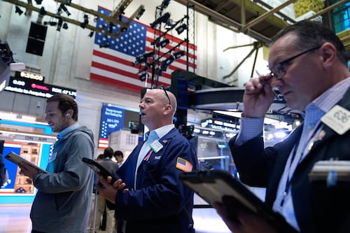 Most of Wall Street rises as oil prices continue to ease, even as chip stocks keep dropping