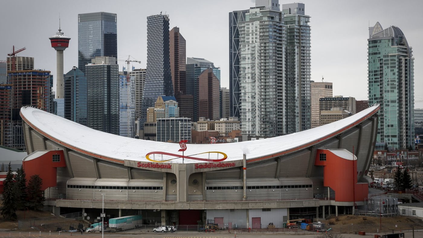 The city skyline is seen behind the Saddledome in Calgary, Alta., on Thursday, March 12, 2020. (THE CANADIAN PRESS/Jeff McIntosh)