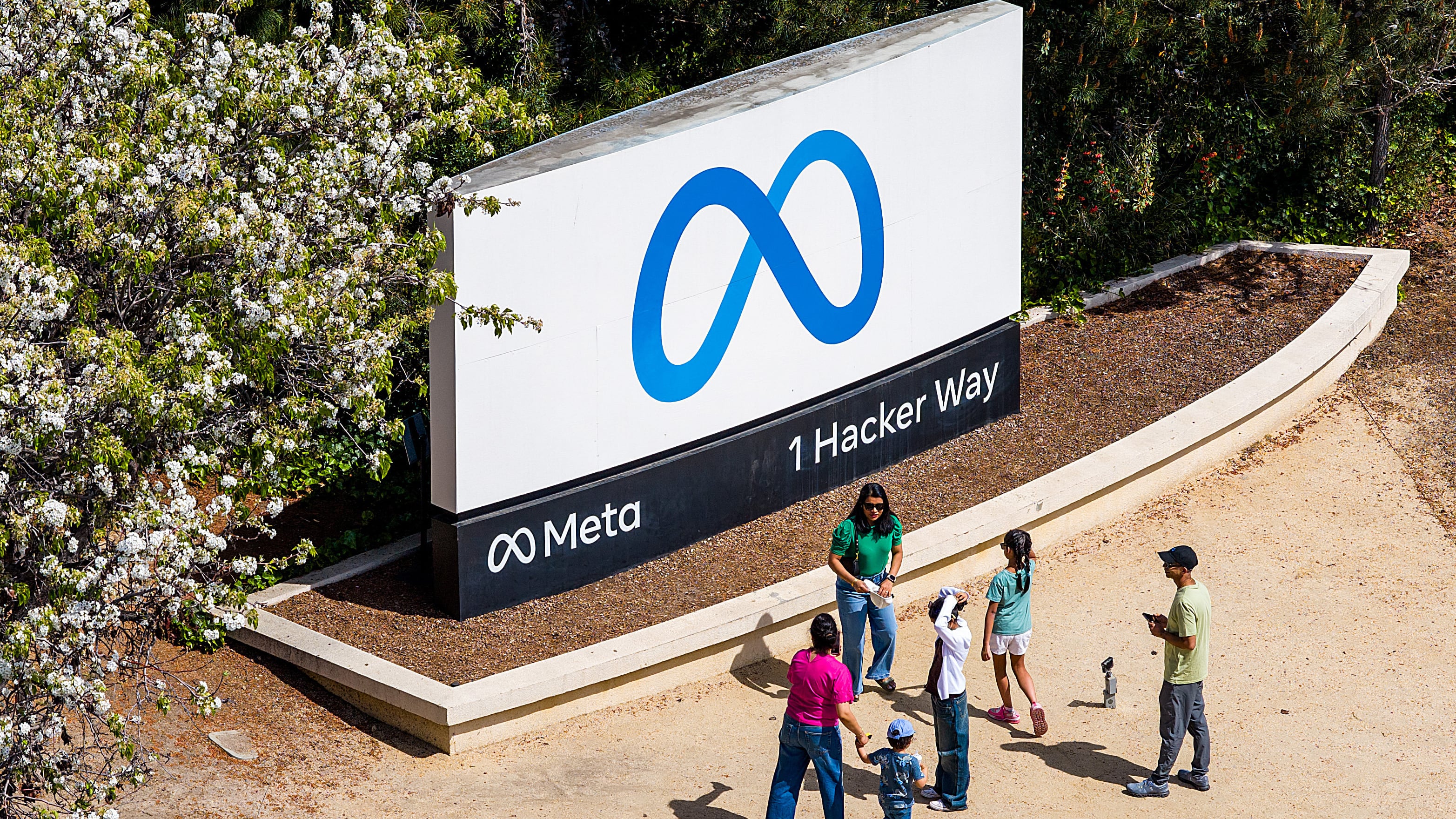 Visitors gather at a sign outside Meta headquarters in Menlo Park, Calif., on March 26, 2026. (Noah Berger / AP Photo)
