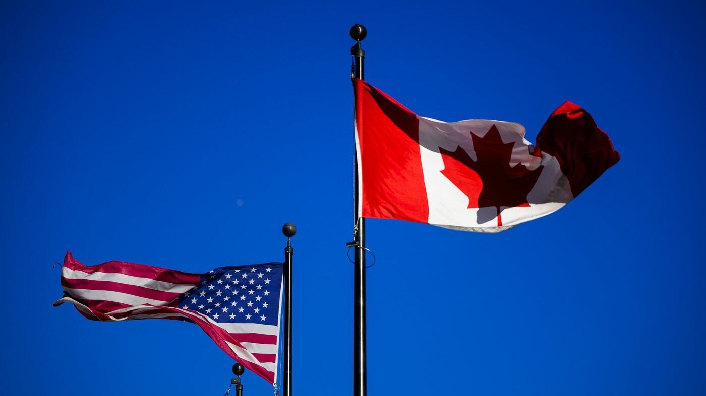 The flags of Canada and the United States fly outside a hotel in downtown Ottawa, on Saturday, Feb. 1, 2025. THE CANADIAN PRESS/Justin Tang