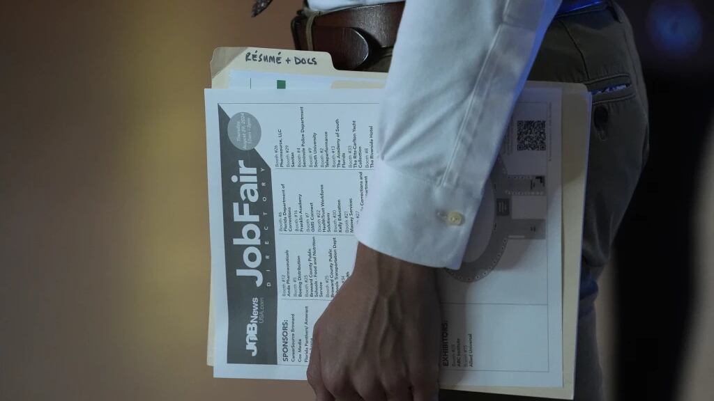 A person waits in a line for a prospective employer at a job fair, Thursday, Aug. 29, 2024, in Sunrise, Fla. (AP Photo/Lynne Sladky, File)
