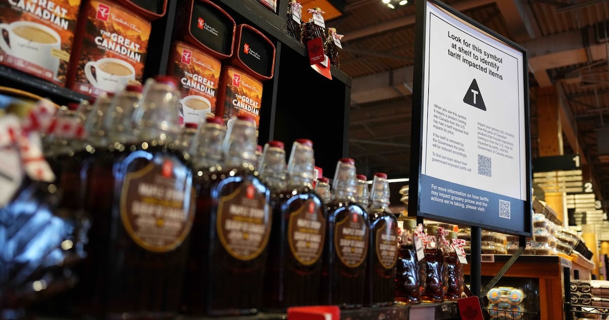 Photo: bnnbloomberg.ca A sign advising that products from the U.S. affected by a tariff will be marked with a symbol at the shelf, along with a QR