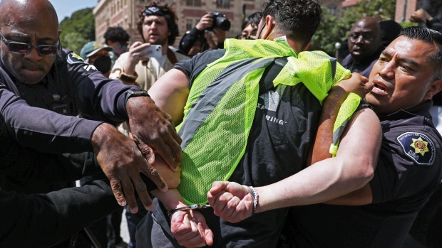 USC police officers detain a pro-Palestine demonstrator on April 24.