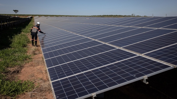 <p>A contractor works on photovoltaic modules on an AES Tiete SA solar farm in Guaimbe, Sao Paulo state, Brazil.</p>