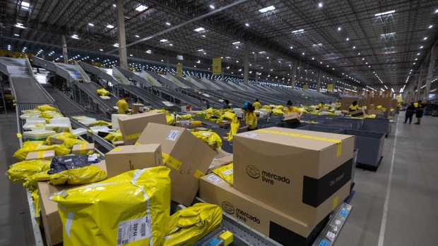 Workers sort packaged products at the MercadoLibre fulfillment center in Sao Paulo, Brazil, on Friday, Nov. 24, 2023. Earlier this month, MercadoLibre delivered strong top-line results ahead of expectations and margin improvements as it executes well, generating momentum heading into the holiday season. Photographer: Jonne Roriz/Bloomberg