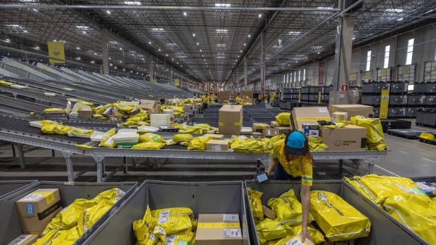 A worker sorts packaged products at the MercadoLibre fulfillment center in Sao Paulo, Brazil, on Friday, Nov. 24, 2023. Earlier this month, MercadoLibre delivered strong top-line results ahead of expectations and margin improvements as it executes well, generating momentum heading into the holiday season. Photographer: Jonne Roriz/Bloomberg