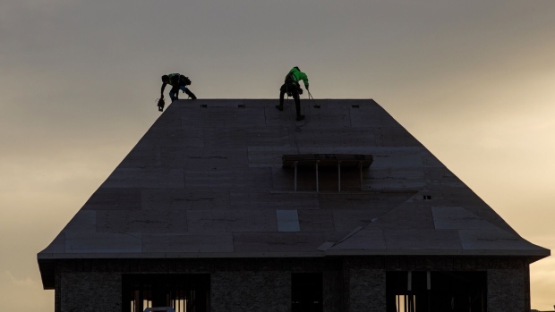 Workers at a home under construction in Vaughan, Canada, on Tuesday, Dec. 20. 2022. Canadian home prices fell for a ninth straight month as sharply rising interest rates prompted both buyers and sellers to withdraw from the market heading into the traditionally slower winter season. Photographer: Cole Burston/Bloomberg
