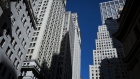 Buildings stand on Wall Street near the New York Stock Exchange in New York. Photographer: John Taggart/Bloomberg