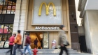 Pedestrians walk past a McDonald's Corp. restaurant in Shanghai, China, on Wednesday, Nov. 22, 2023. Carlyle Group Inc. agreed to sell its entire stake in McDonald's China operation to the hamburger chain operator for about $1.8 billion, reaping a 6.7 times return in one of the investment giant’s best exits from the Asian nation. Photographer: Qilai Shen/Bloomberg
